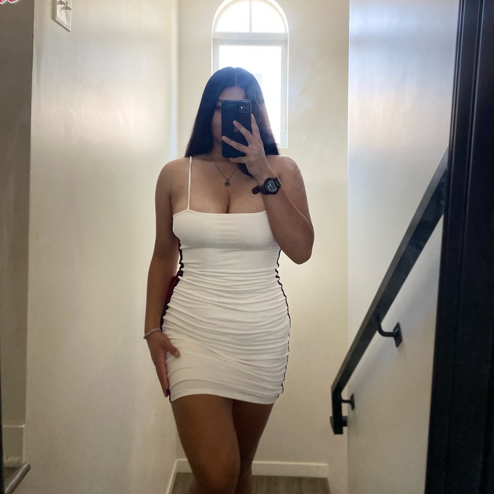 Fitted White dress with red stripes on the sides.